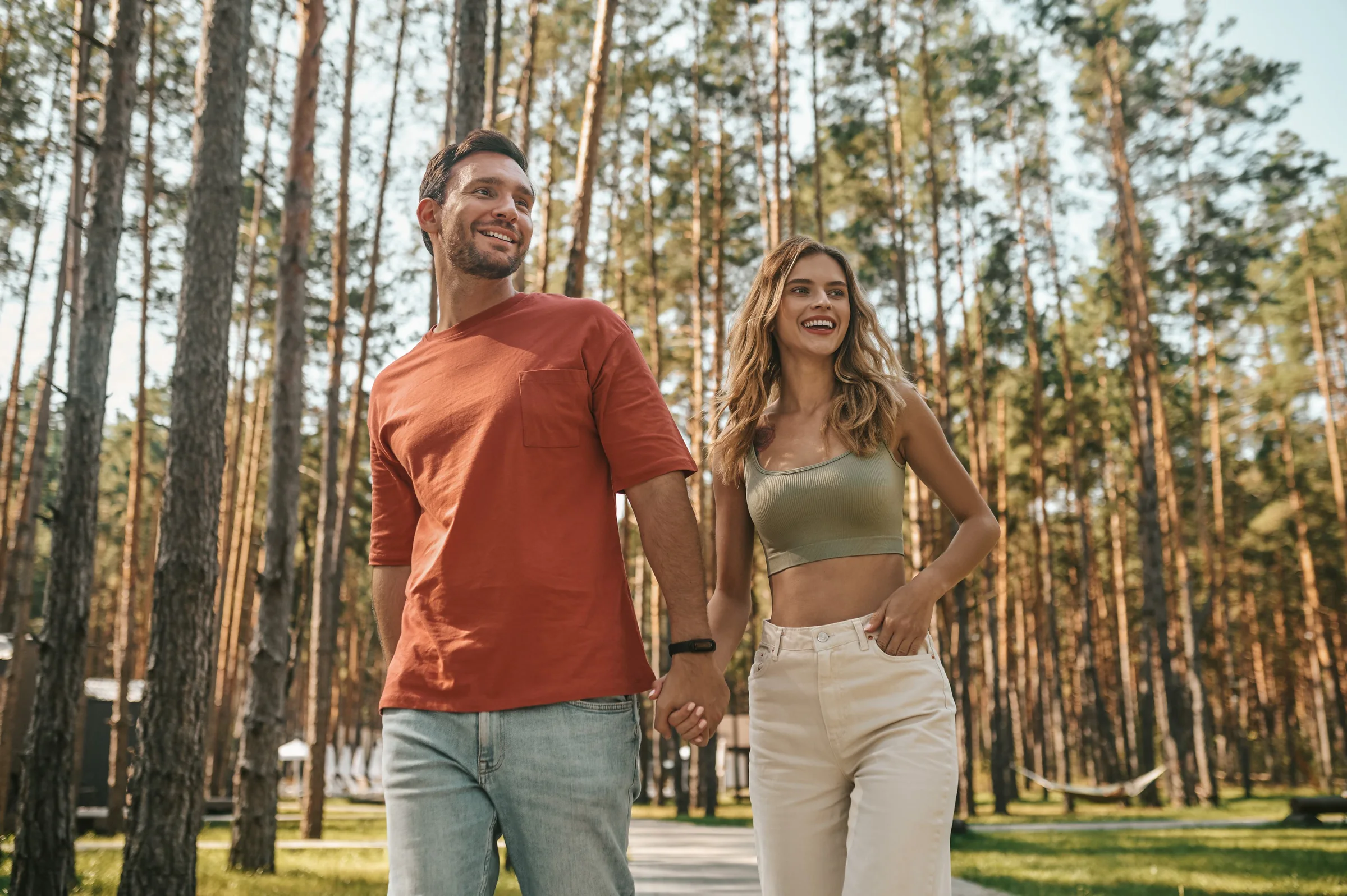 A couple walking together through a forest